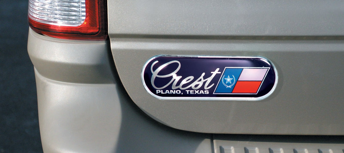 Chrome auto ad dealer badge on a vehicle trunk