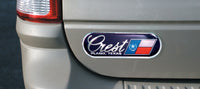 Chrome auto ad dealer badge on a vehicle trunk