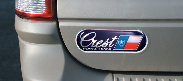 Chrome auto ad dealer badge on a vehicle trunk