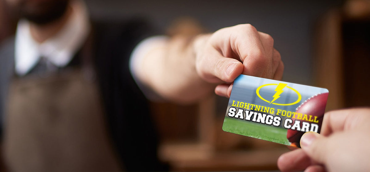 Custom printed loyalty savings card being handed to a customer
